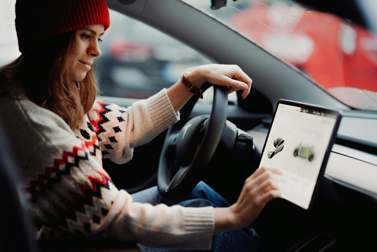 young woman using car dash screen